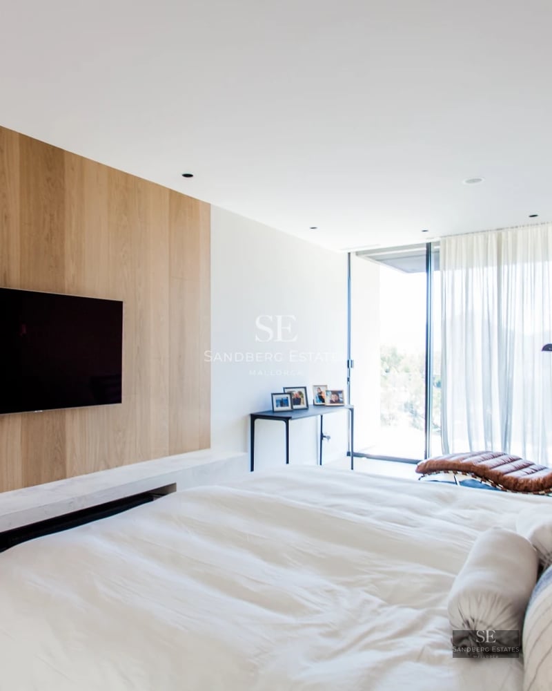 Exterior view of a modern house with pool. Minimalist architecture, large windows, and lush landscaping.