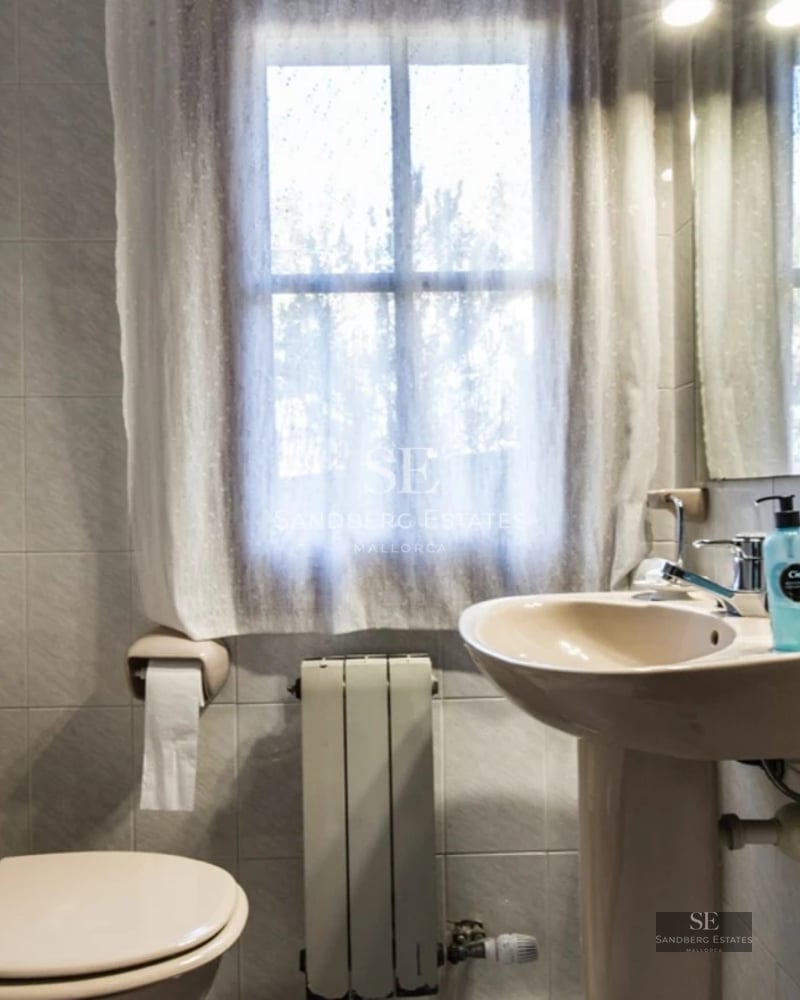 Spacious living room with large windows, modern sofas, coffee table, and panoramic sea views. Elegant and bright design.