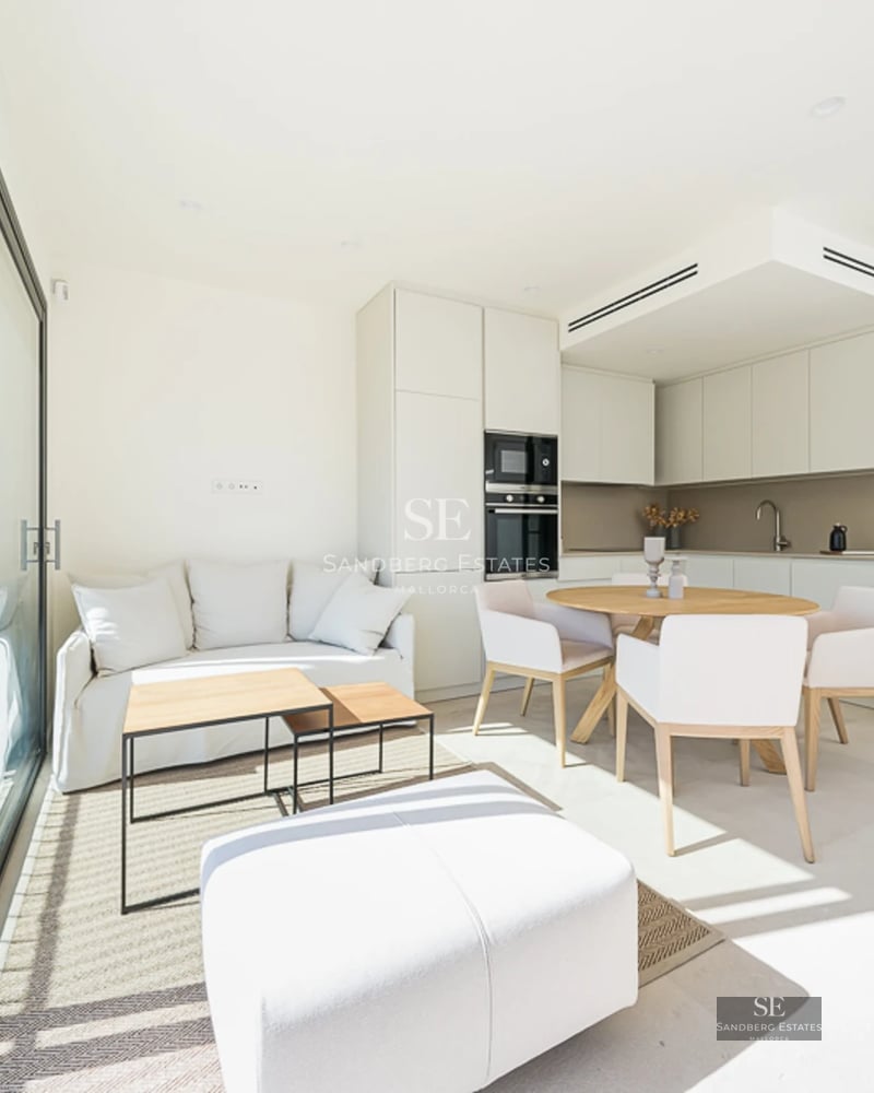 Spacious living room with window walls, modern furniture, and access to a terrace with a pool. Elegant and bright design.