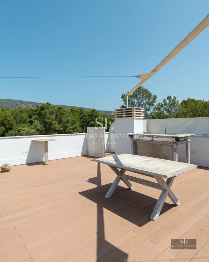 Modern villa featuring a minimalist facade, large windows, a pool, and a lush garden. Warm ambient lighting.