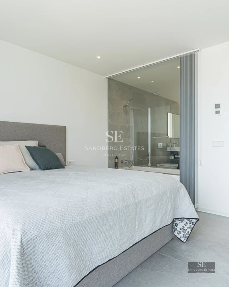 Spacious balcony with panoramic sea views. Modern and elegant furniture. Warm ambient lighting.