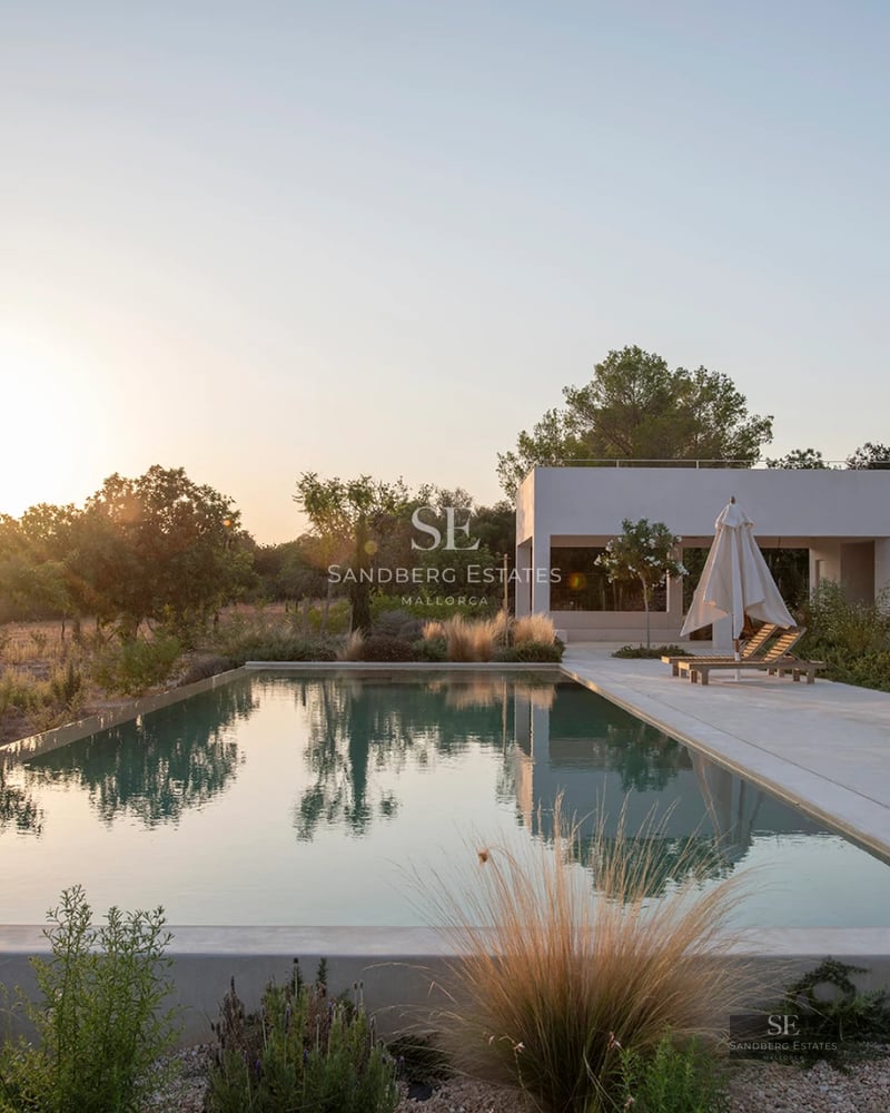 Exterior view of modern villa with infinity pool, terrace, and garden. Minimalist design, natural lighting, and panoramic views.