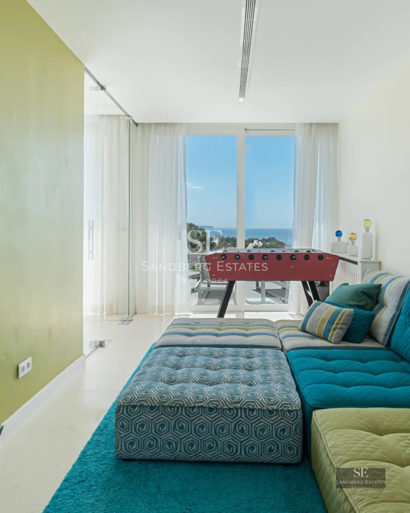 View of a modern villa with reflecting pool. Minimalist architecture, large windows and lush landscaping.