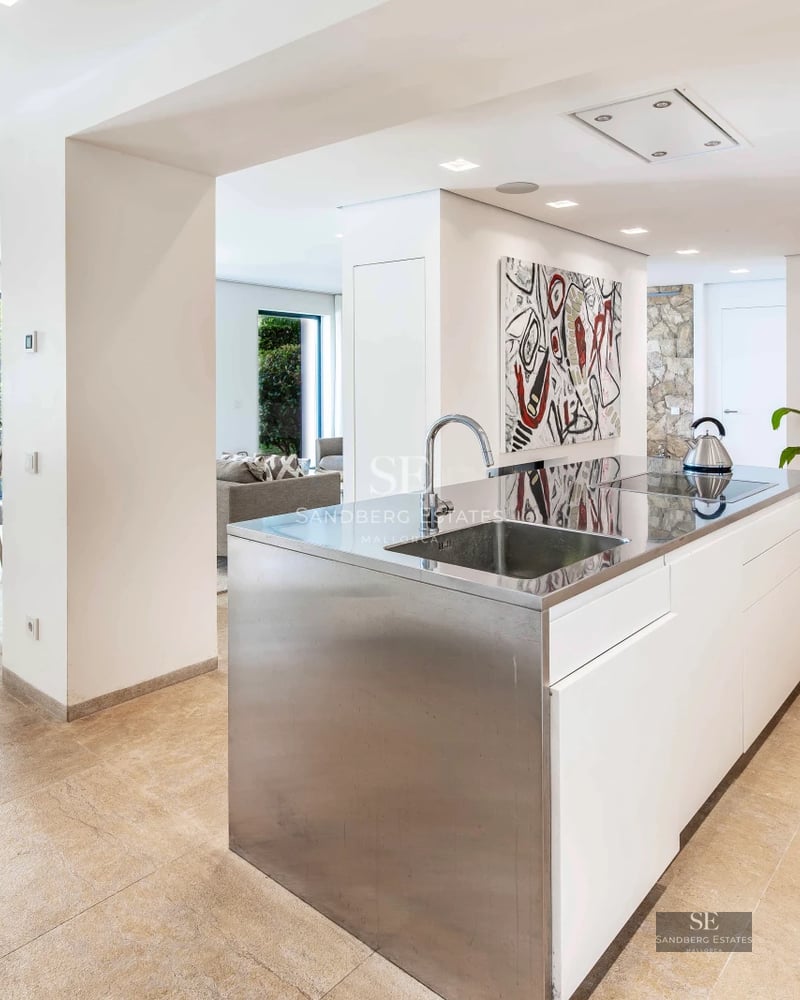 Exterior view of a modern villa with infinity pool, surrounded by greenery. Sleek architecture and contemporary design.