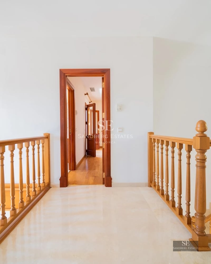 Exterior view of a modern villa with an infinity pool, expansive terraces, and minimalist design. Lush garden and abundant natural light.