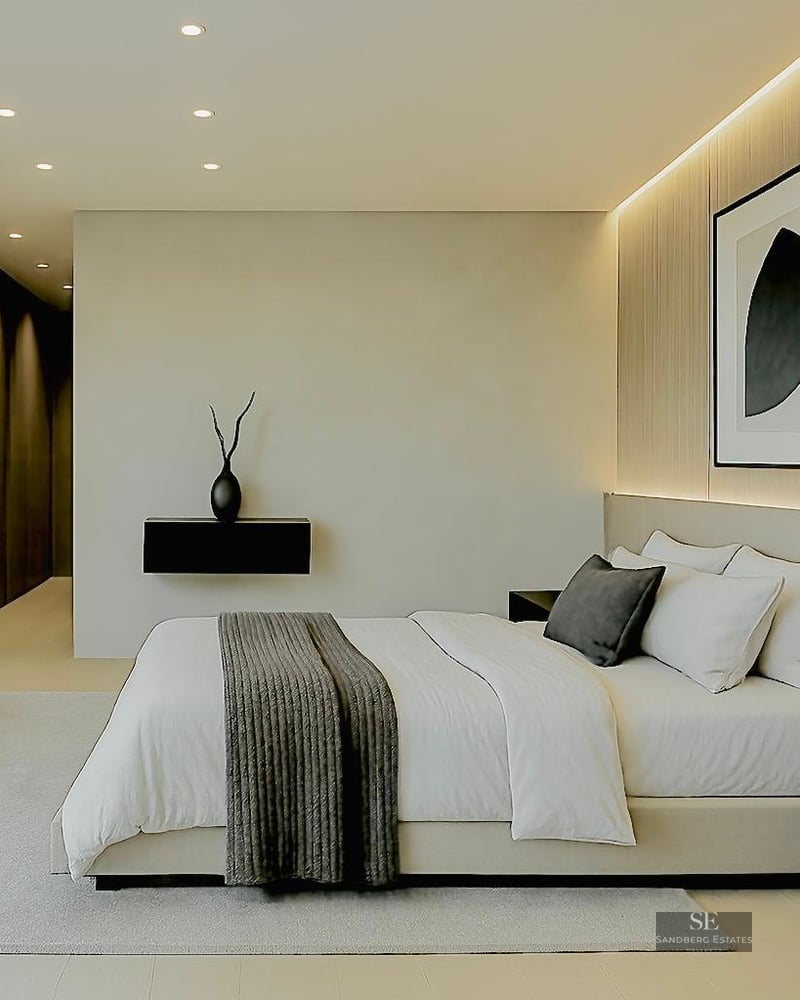Modern master bedroom with neutral tones, textured wall panels, and abstract art on the wall.
