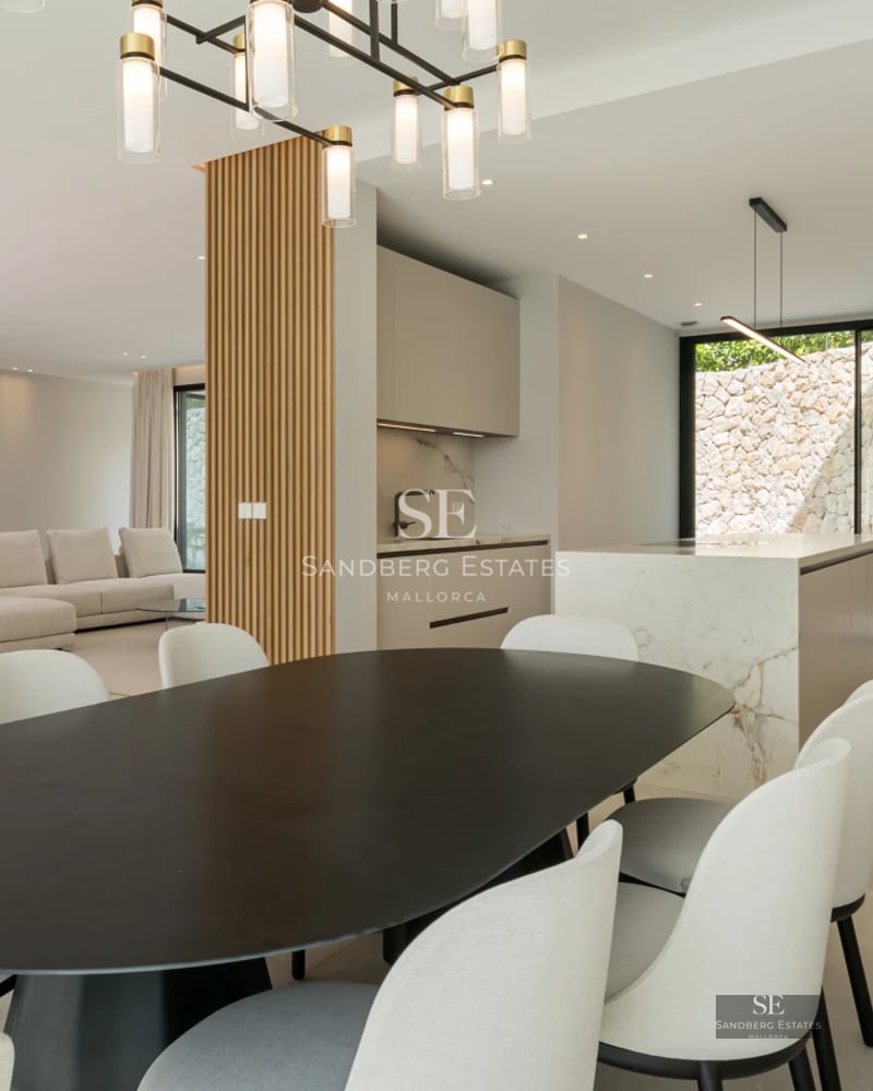 Spacious terrace with infinity pool, sun loungers, and panoramic sea views. Modern design with elegant furniture and lush greenery.