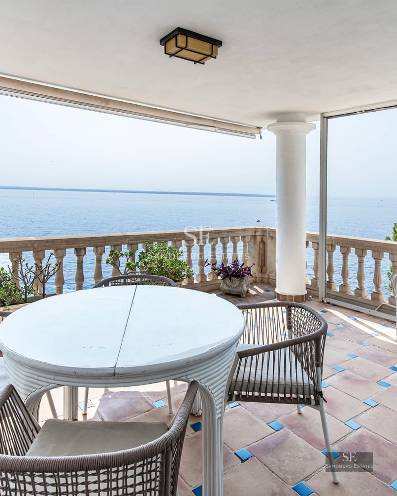 Exterior view of a modern villa with swimming pool, garden, and terrace. Minimalist design with large windows and natural light.