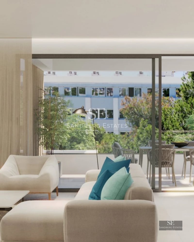 Bright living room with large windows, balcony overlooking the sea, wooden floors and modern furniture. Elegant and comfortable design.