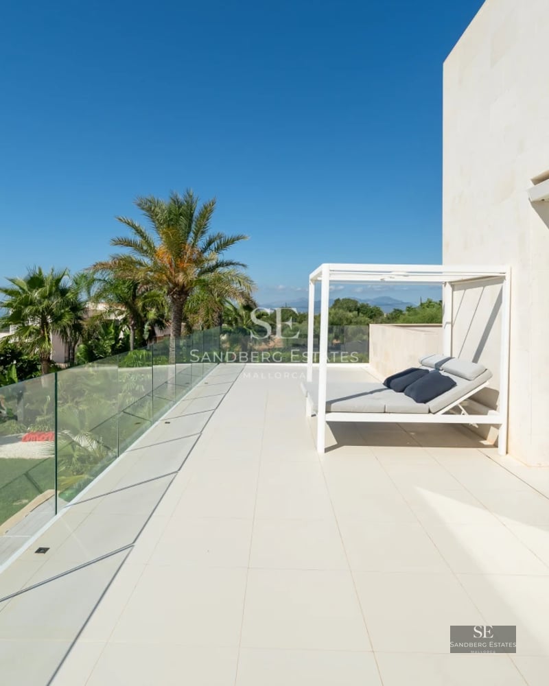 Exterior view of a modern villa featuring a pool, large glass windows, and lush garden. Minimalist design and high-quality finishes.