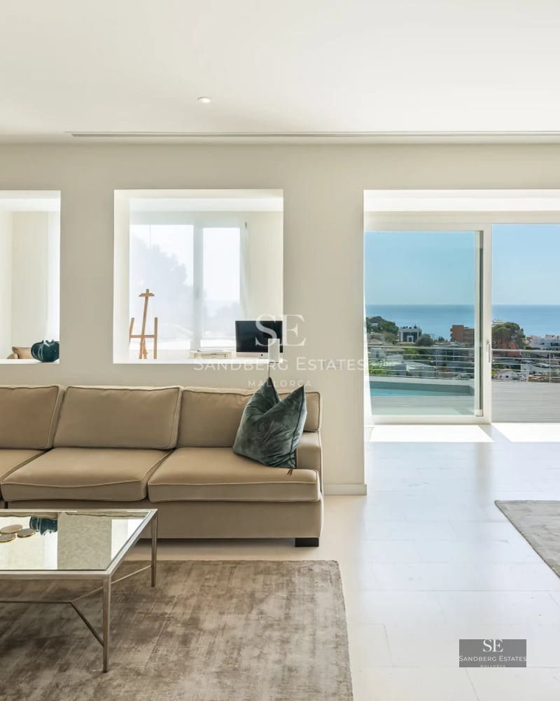 Exterior view of a modern villa with an infinity pool, lush garden, and spacious terraces. Elegant design with high-quality materials.