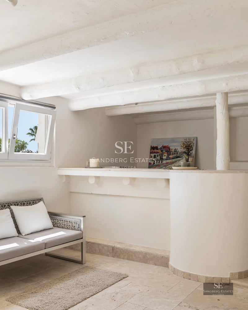 Modern facade with reflecting pool. Large windows, manicured landscaping, and minimalist design. Warm lighting.