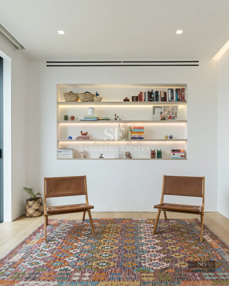 Modern exterior featuring a reflective pool, lounge chairs, lush greenery, and sleek architecture. Ideal for relaxed, luxurious living.