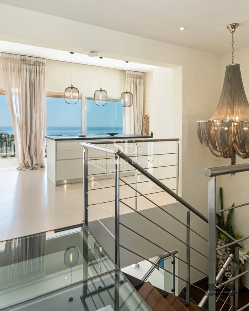 Garden view featuring a pool, terrace, and lush vegetation. Modern design with large windows and high-quality finishes.