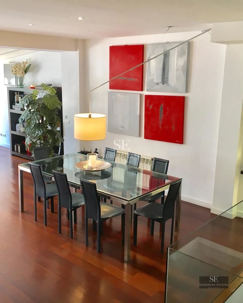 Spacious living room with large windows, light wood flooring, modern furniture and panoramic sea views. Abundant natural lighting.