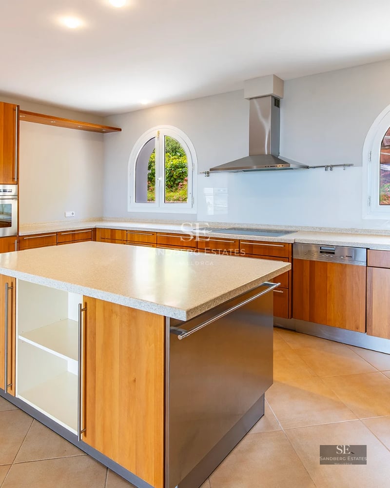 Expansive pool surrounded by lush greenery, with a modern villa in the background and a bright blue sky. Luxury and serenity.