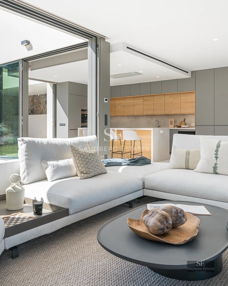 Exterior view of a modern villa featuring a pool, lush garden, and large windows. Minimalist architectural design.