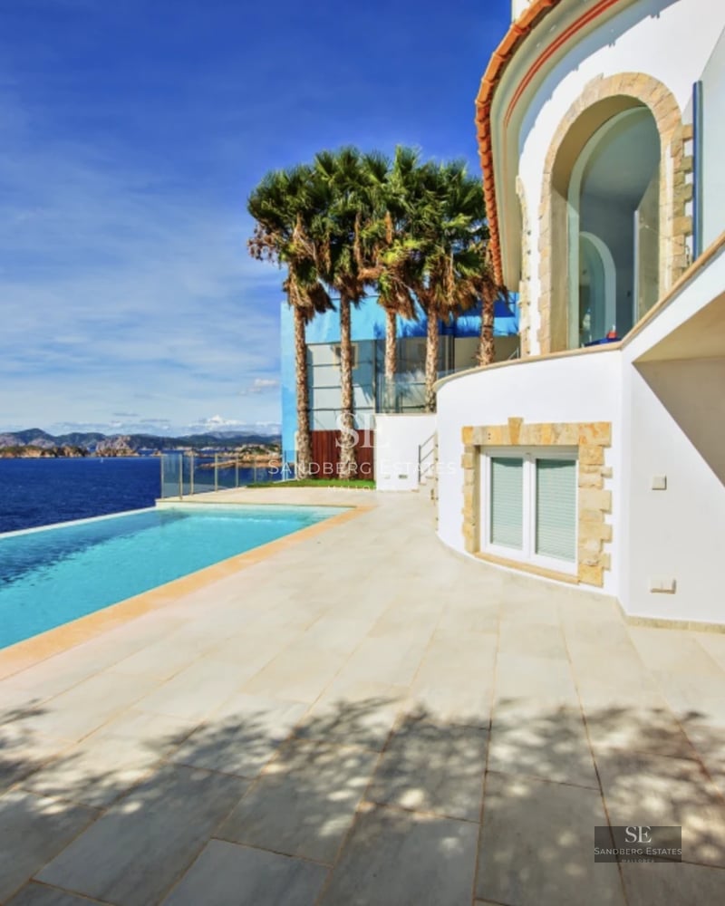 Spacious terrace featuring an infinity pool, panoramic sea views, modern furniture, and minimalist architectural design.