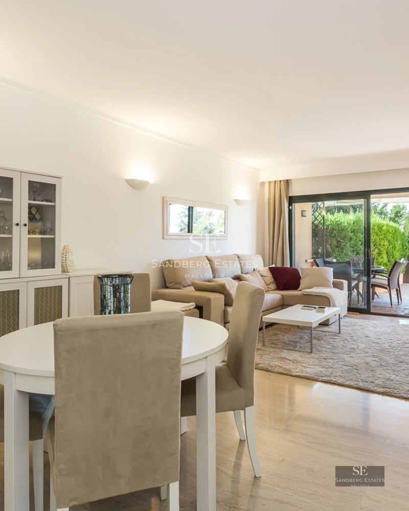 Modern apartment with a glazed balcony overlooking the sea. Minimalist design, light wood flooring and elegant furniture.