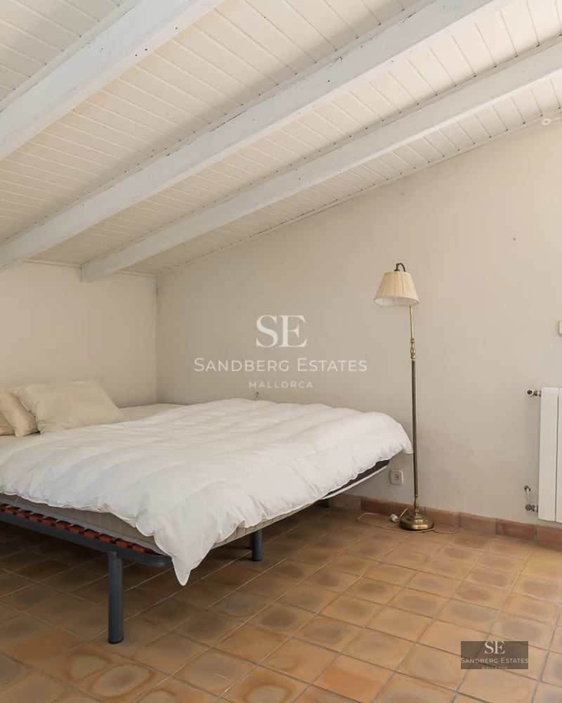 Spacious living room with large windows, light wood floors, modern sofas, and panoramic sea views. Natural lighting and minimalist decor.