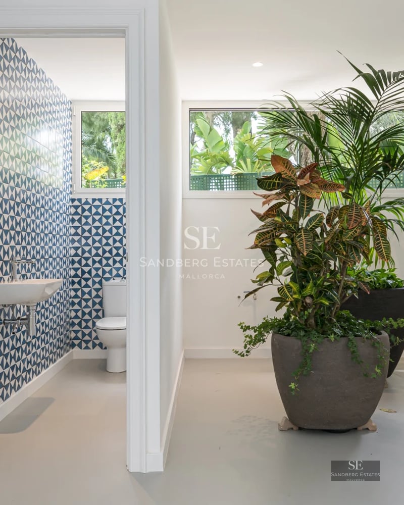 Spacious terrace featuring an infinity pool, sun loungers, and ocean views. Modern design with natural materials and warm lighting.