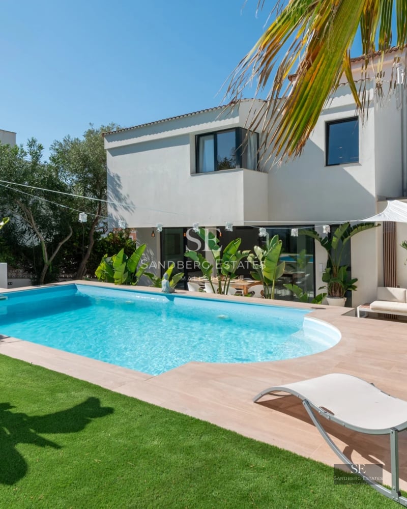 Exterior view of a modern villa with a pool. Sleek design, large windows, and landscaped surroundings. Ideal for investment.