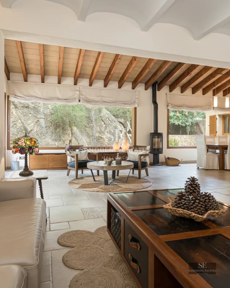 Spacious living room with natural light, modern fireplace, floor-to-ceiling windows & terrace access. Minimalist decor & designer furniture. Panoramic views.