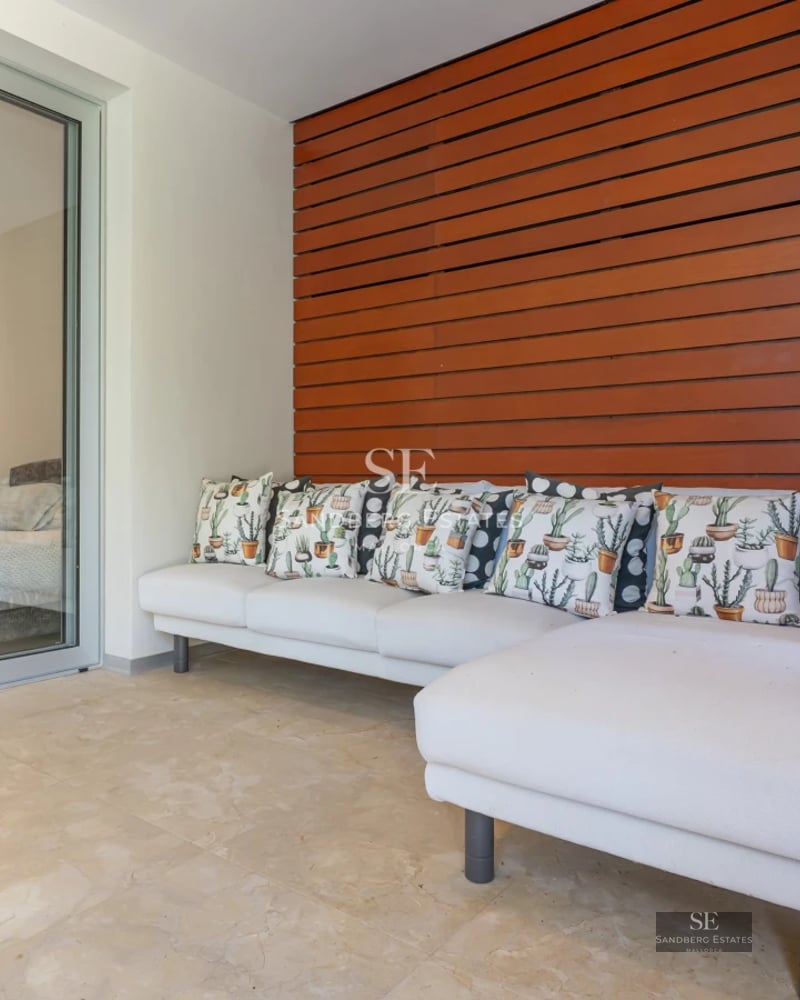 Expansive terrace with infinity pool. Modern design featuring sleek outdoor furniture and panoramic sea views. Luxury and comfort.