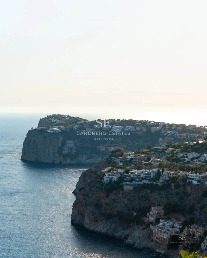 Spacious terrace with infinity pool and panoramic sea views from luxury apartment. Modern furniture and elegant design.