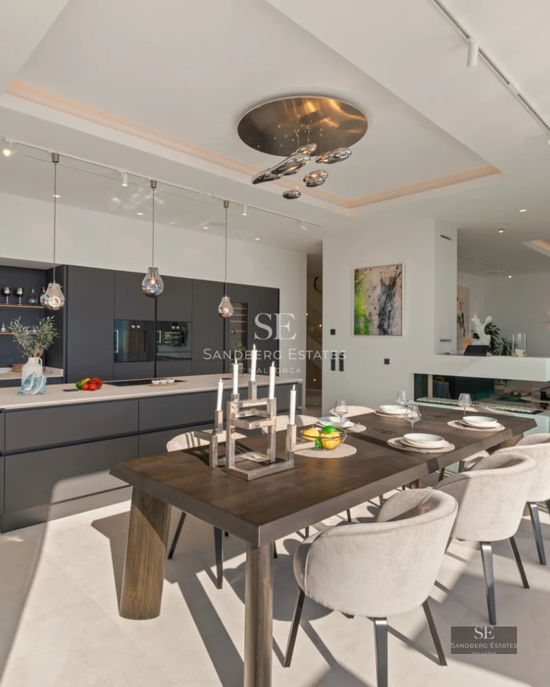 Spacious living room with floor-to-ceiling windows, shimmering pool, and lush garden. Modern interior design with high-quality finishes.