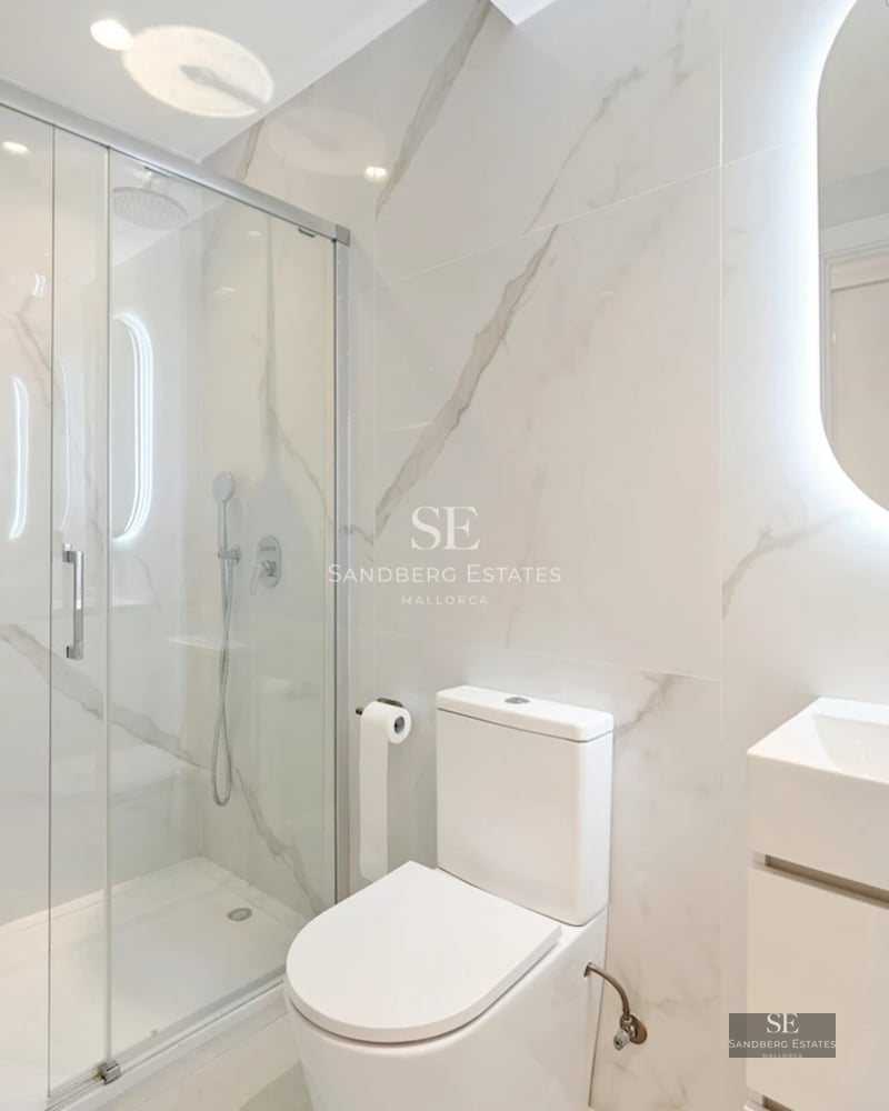 Spacious balcony with sea views. Modern furniture, glass railing. Perfect for relaxing and enjoying the sunset.