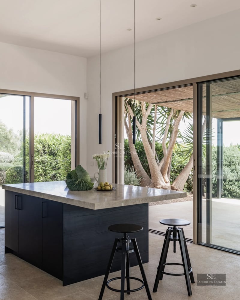 Spacious living room with sea view windows. Modern design with elegant furniture and wooden floors. Abundant natural light.