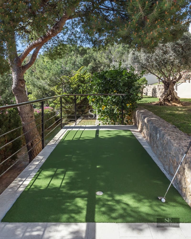 Bright living room with large windows, beige sofa, modern fireplace, and panoramic sea views. Elegant and minimalist design.
