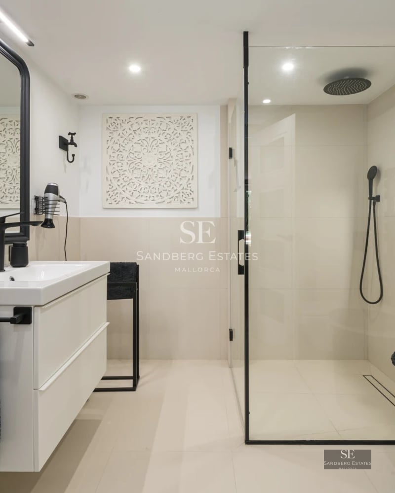 View of modern villa with pool, sun loungers, and lush greenery. Minimalist design featuring large windows.