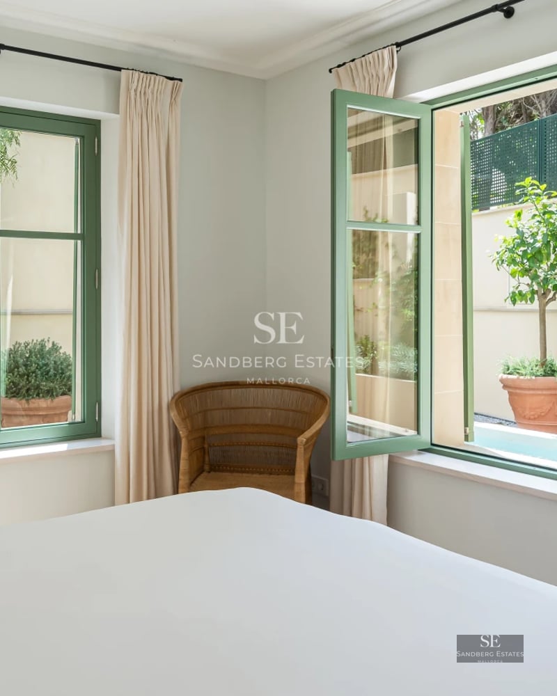 Exterior of a modern villa with a pool, large windows, and lush gardens. Minimalist and elegant design.