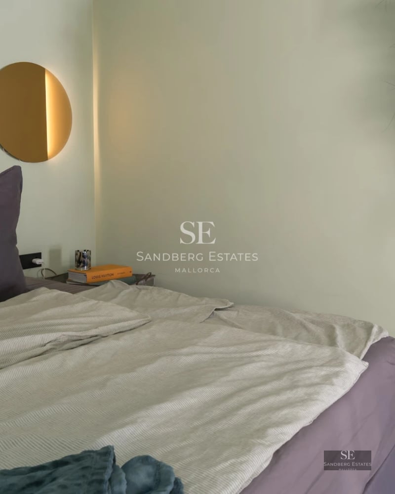 Large swimming pool with sun deck, surrounded by greenery. Modern architecture with large windows and terrace. Ideal for outdoor living.