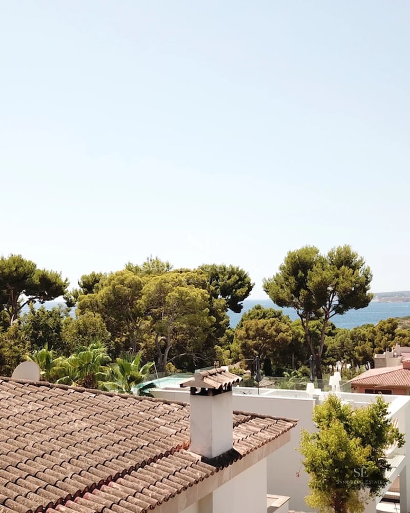 Spacious terrace with sea view. Modern design, elegant outdoor furniture, and infinity pool.