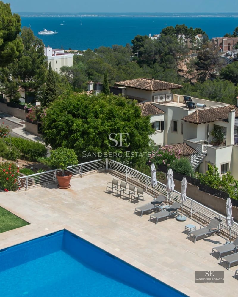 Exterior view of a modern villa with a pool, lush garden, and elegant architecture. Contemporary design with large windows.