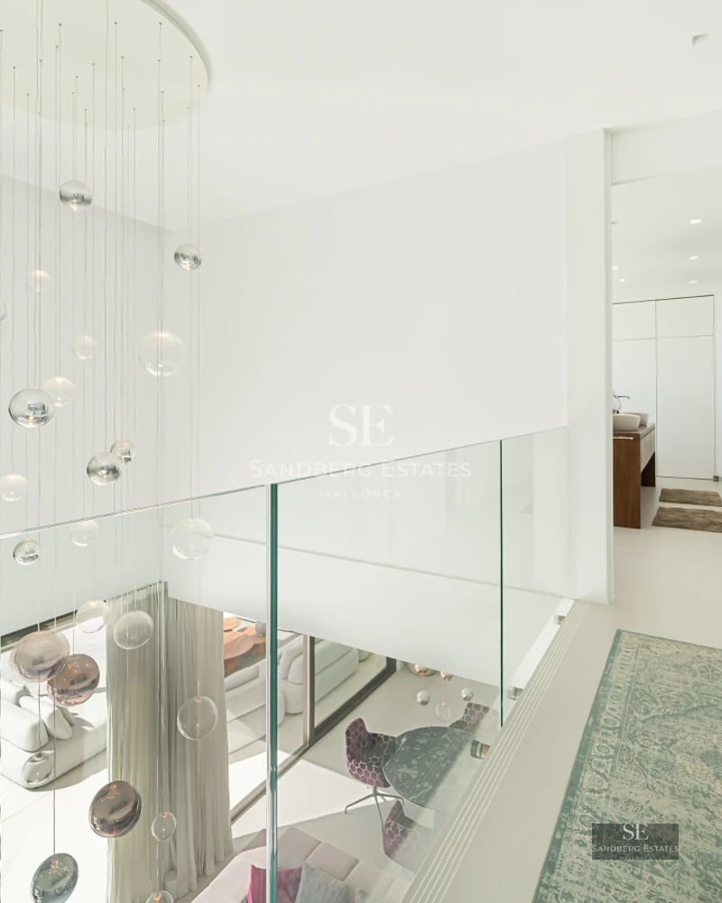 Exterior view of a modern villa featuring an infinity pool, garden, and large windows. Minimalist architecture and elegant landscaping design.