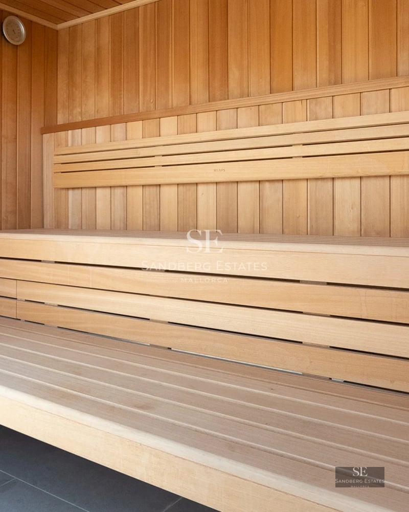 Exterior view of modern villa with pool, garden, and large windows. Minimalist architecture. Clear sky.