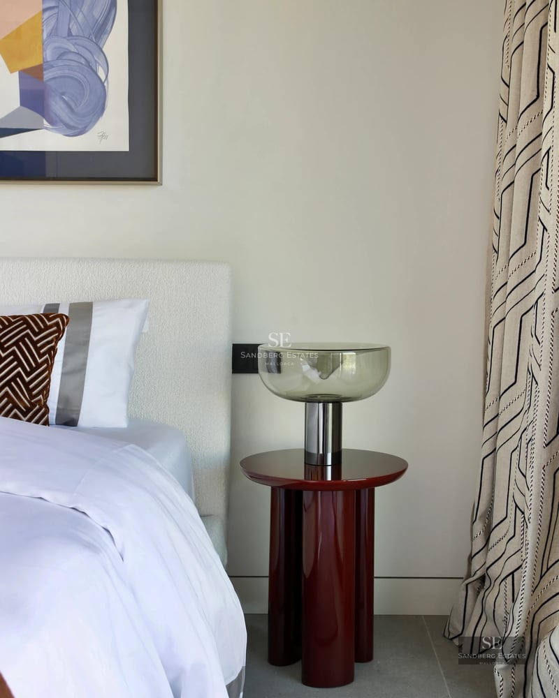 Spacious living room with panoramic windows, balcony with panoramic view, light wood floors, and modern designer furniture. Bright and elegant.