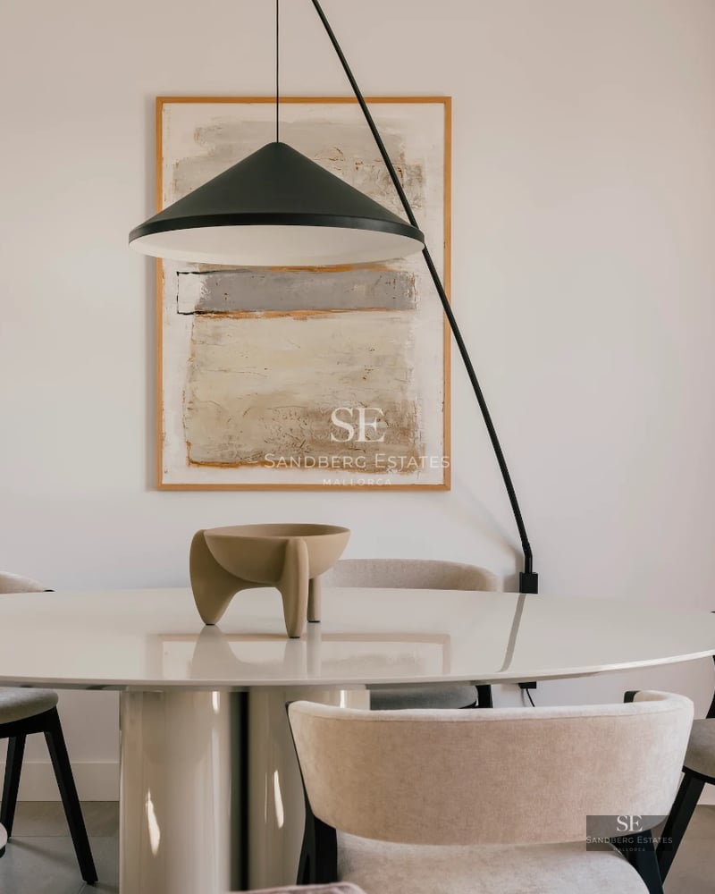 Spacious living room with panoramic windows, modern and elegant design, and breathtaking sea views. Natural and warm lighting.