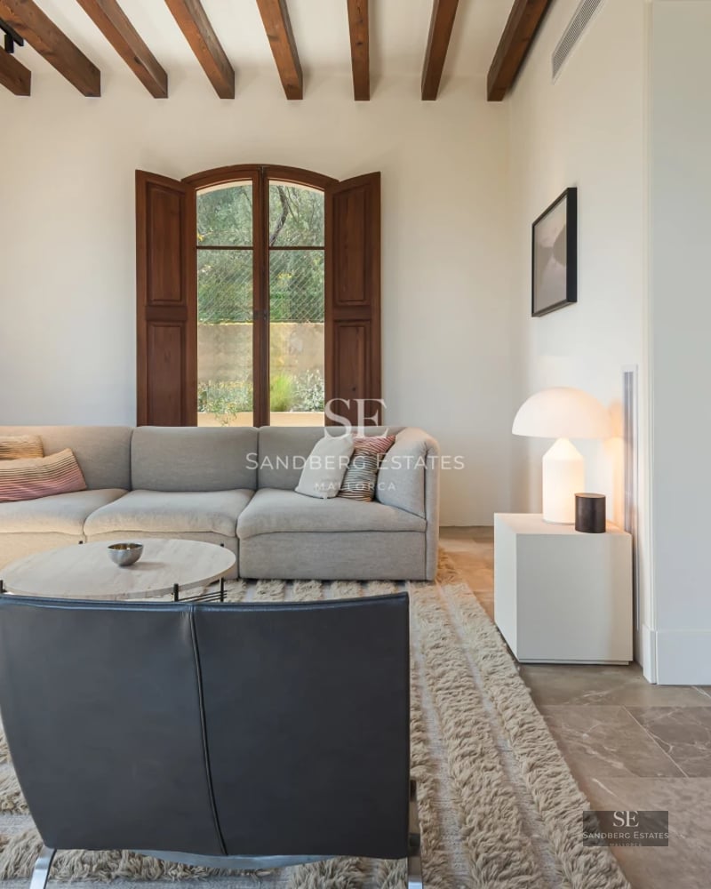 Spacious balcony with sea view, modern furniture, glass railing, wooden floor and retractable awning. Elegant and bright design.