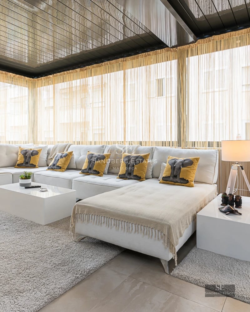 Spacious terrace with pool and sea views. Modern design with sun loungers, umbrellas, and lush vegetation. Ideal for relaxation.