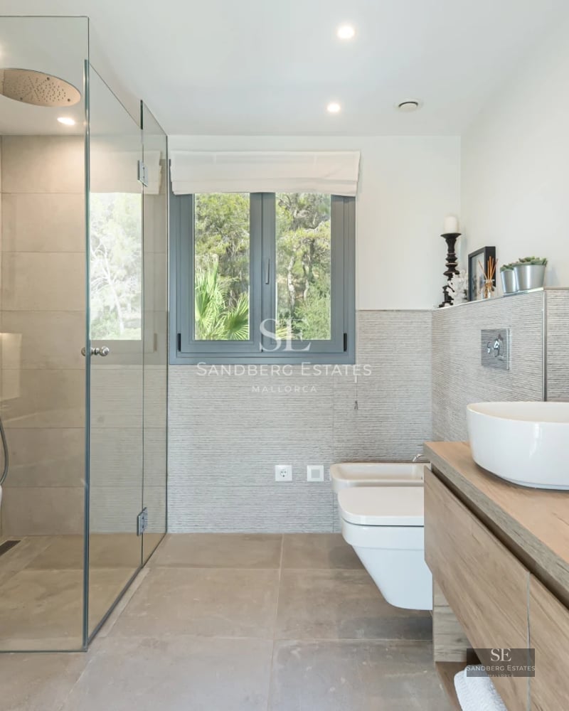 Aerial view of a modern villa featuring a swimming pool, lush garden, and minimalist architecture. Luxury and design at its finest.