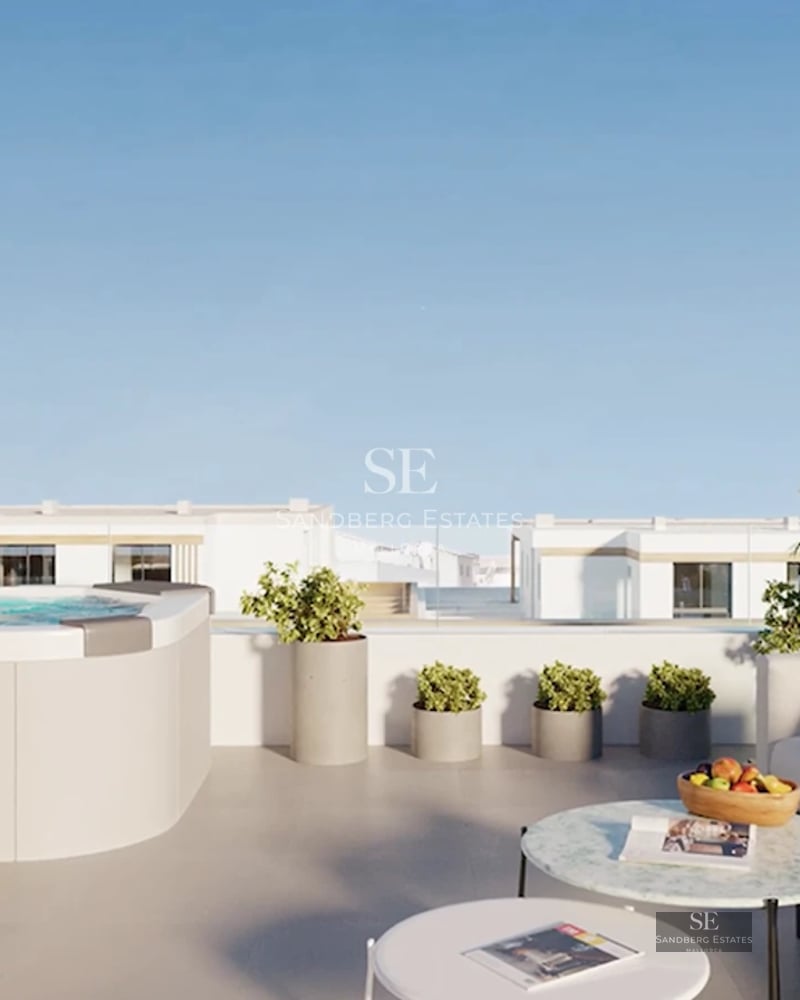 Spacious living room with panoramic windows, light wood flooring, modern fireplace, and breathtaking sea views.