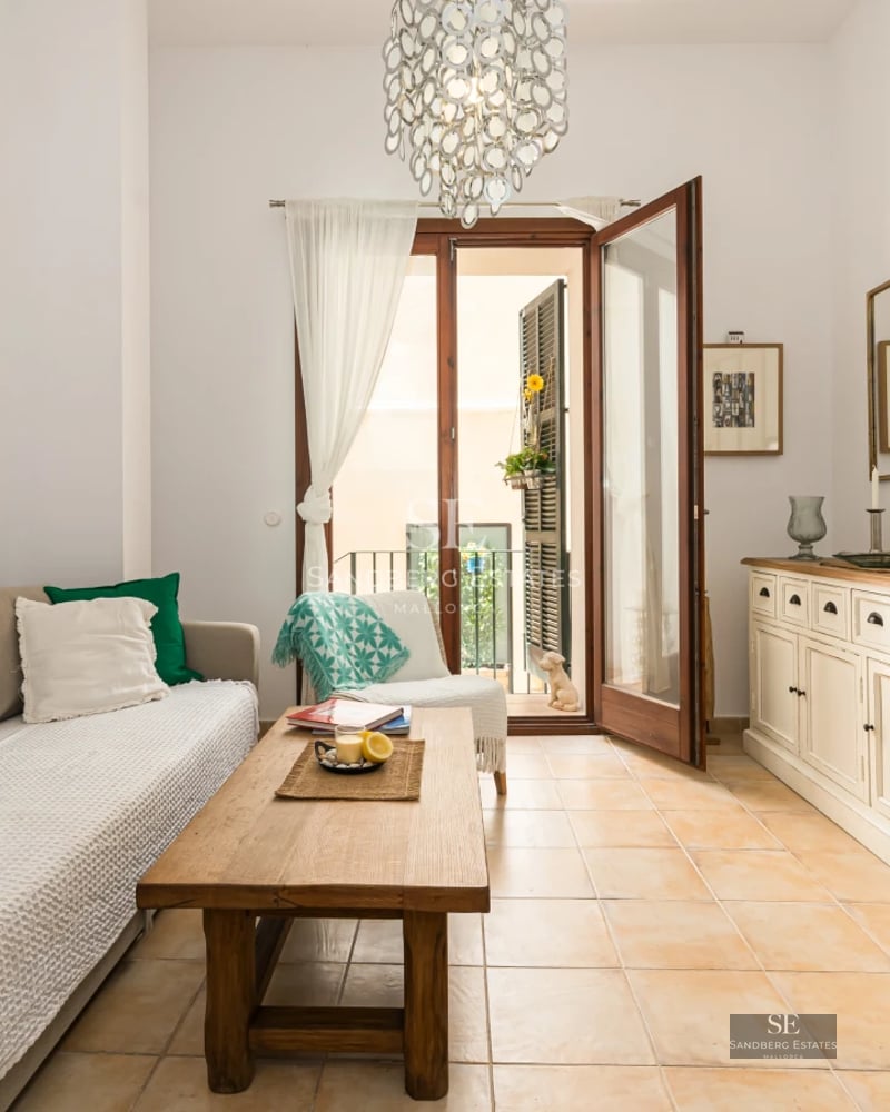 View of a luxurious villa with infinity pool, manicured lawn, and modern architecture featuring large windows.