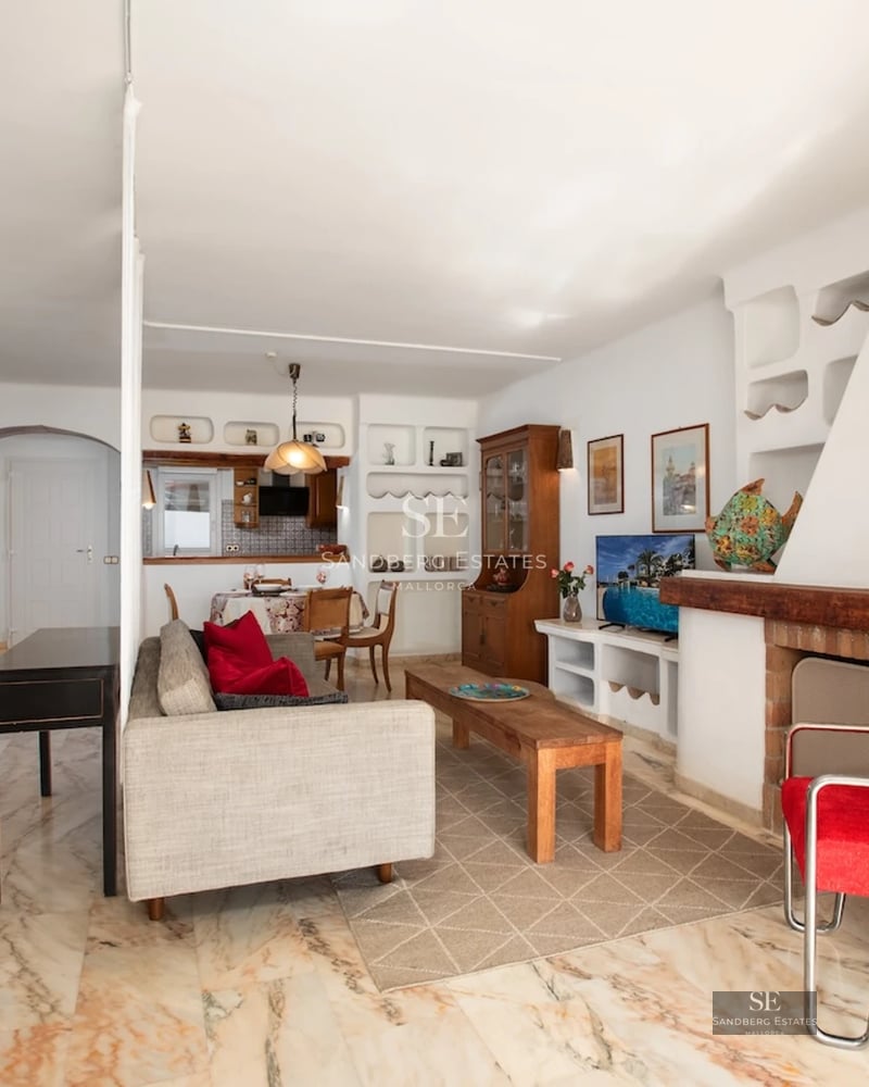 Spacious balcony with sea view. Modern design, glass railing and comfortable outdoor furniture. Soft ambient lighting.