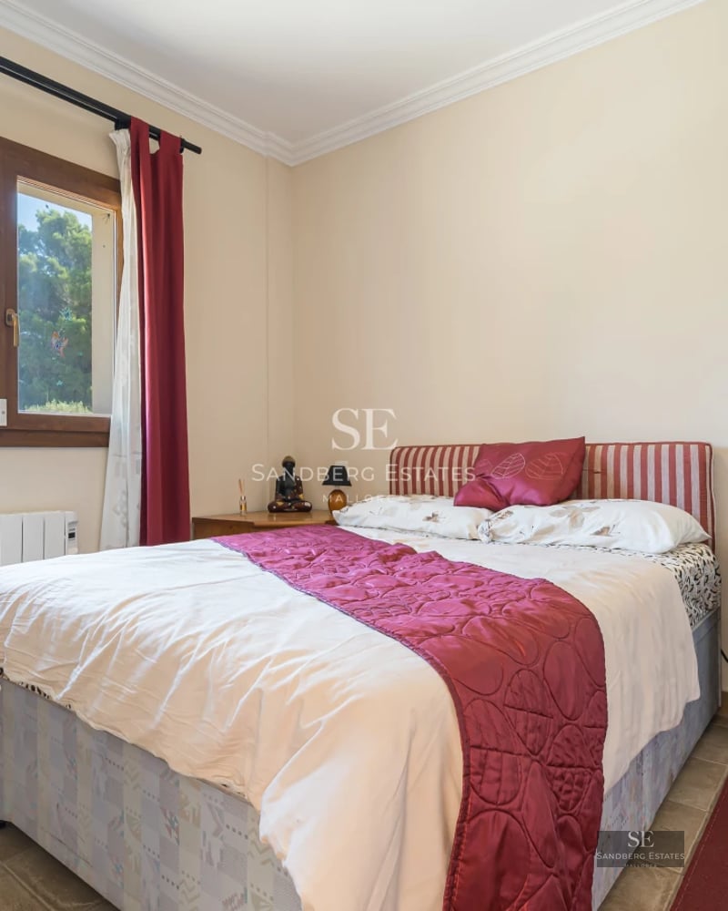 Spacious living room with floor-to-ceiling windows, light wood floors, modern furniture and panoramic views. Abundant natural light.