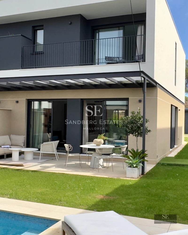 View of an elegant villa with a pool. Modern design, large windows, and high-quality finishes. Natural lighting and lush garden.